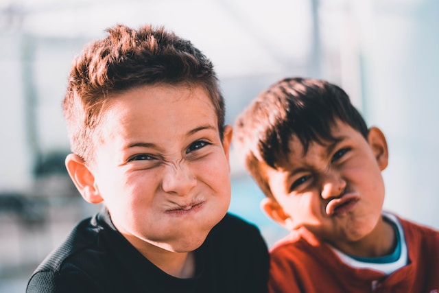 photo of two young boys making silly faces at the camera